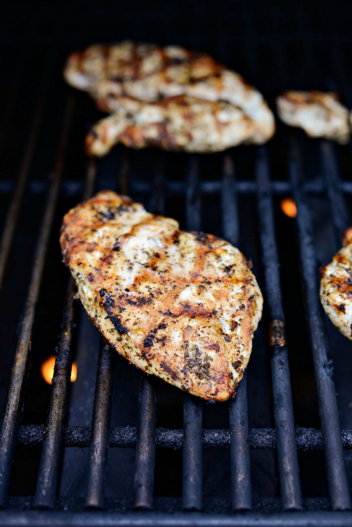 perfectly grilled chicken breast on grill grates.