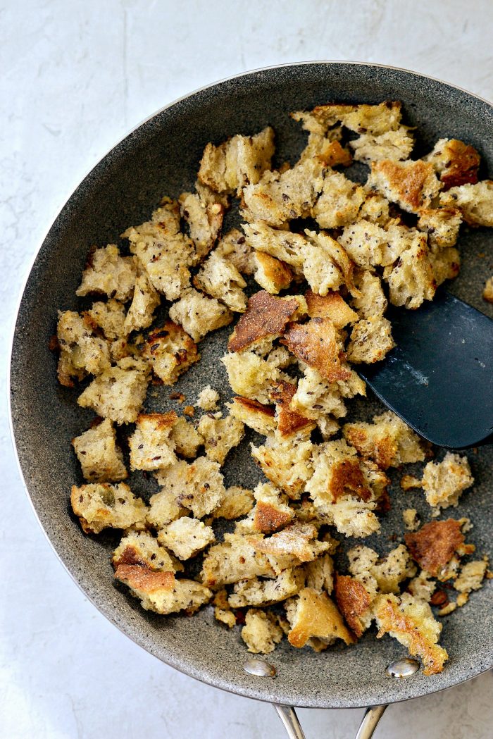hand torn croutons in a skillet