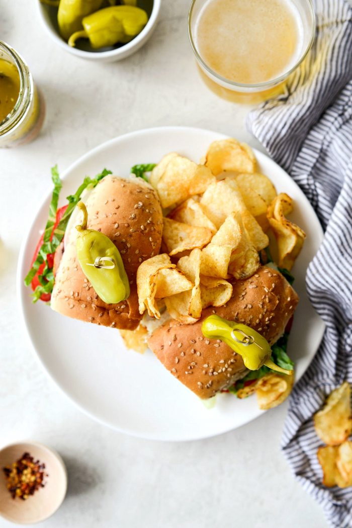 italian sub sandwich on white plate with chips