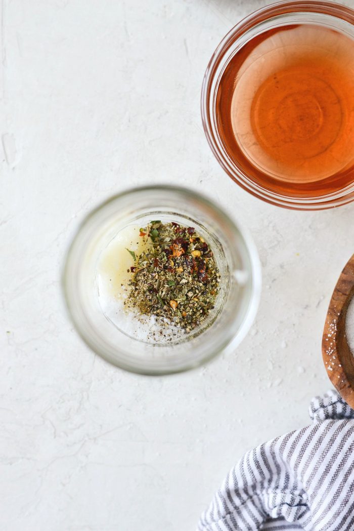 garlic, italian seasoning, salt, pepper and red pepper flakes in a glass jar.