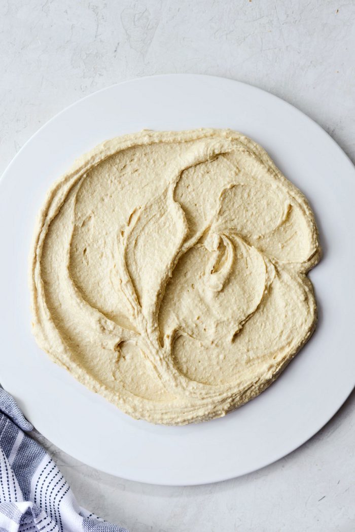 smeared hummus on a white matte platter