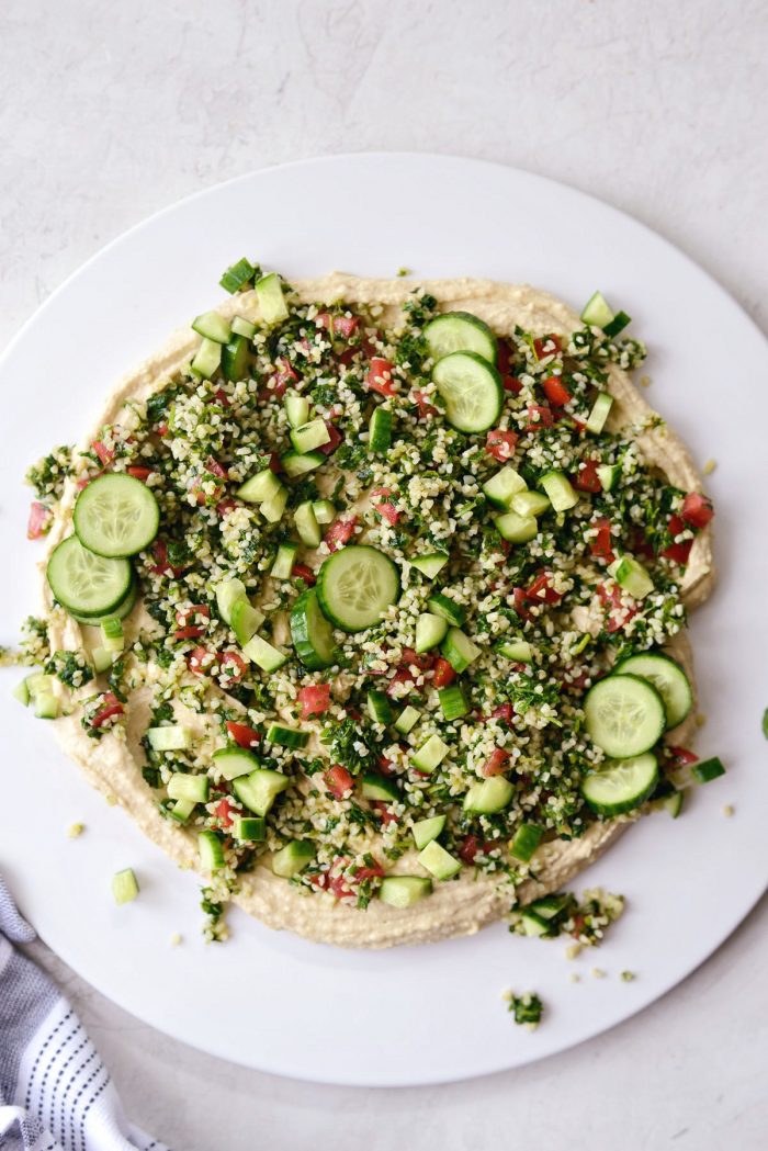 hummus topped with tabbouleh and cucumber