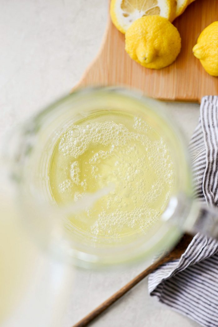 pour in lemon juice in glass pitcher