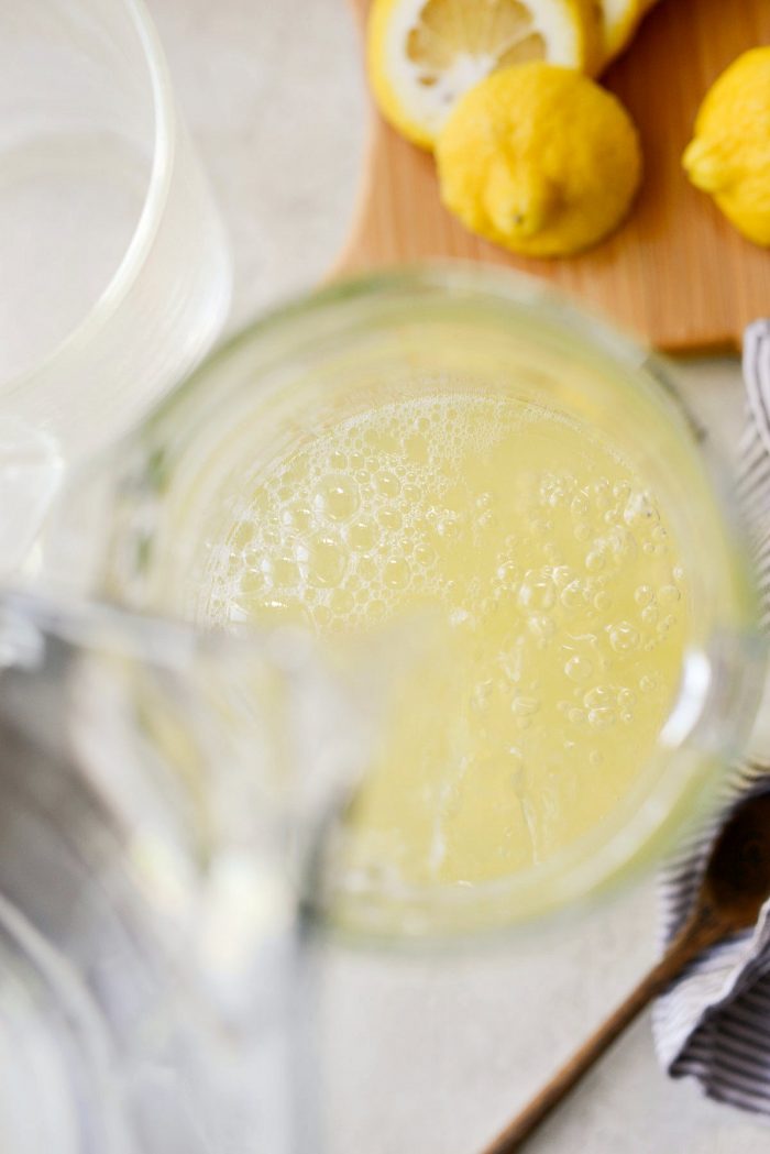 pour water into glass pitcher