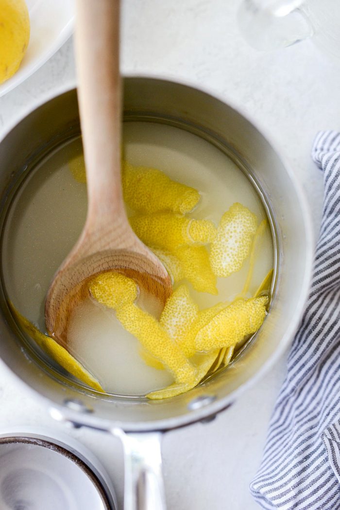 sugar, water and rind in pan with wooden spoon