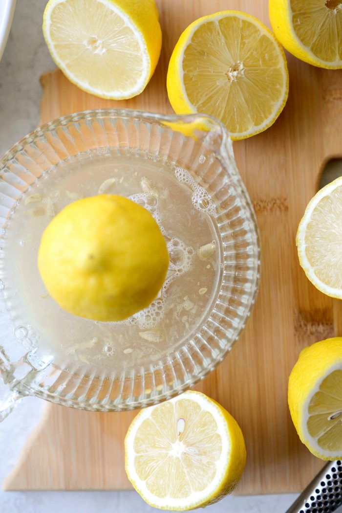 squeezing lemon juice with glass juicer