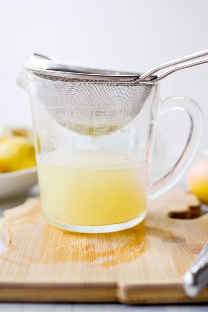 mesh strainer set into measuring cup to catch pulp