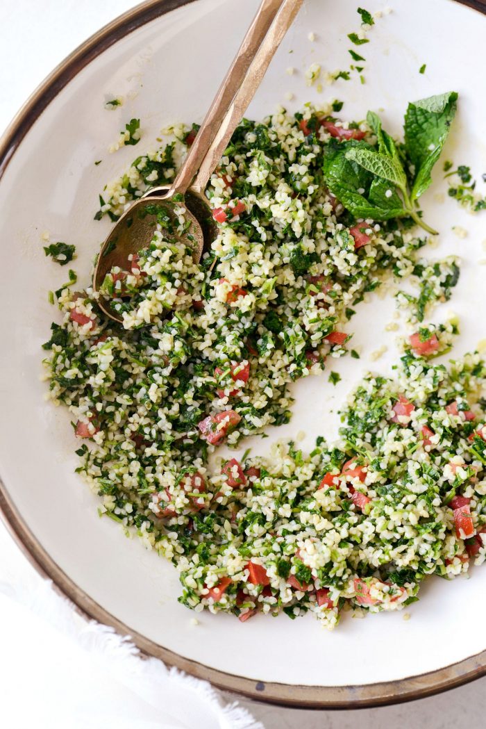 Homemade tabbouleh in a cream bowl with gold rim.