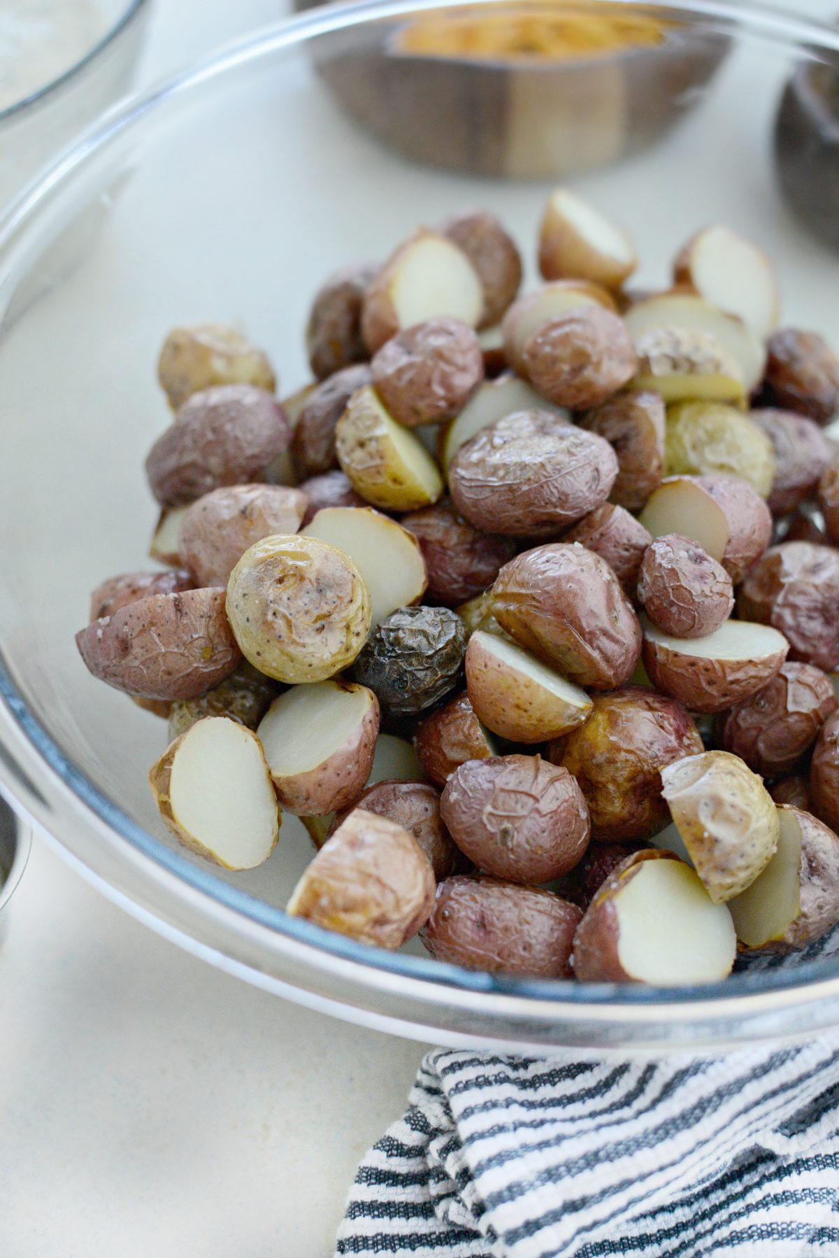 cut potatoes in half and add to a bowl