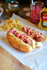 Barbecue sauced chicken brats with pickled red onion and spicy brown mustard