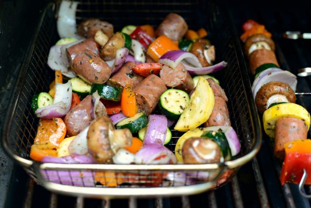 grill basket of veggies and sausages