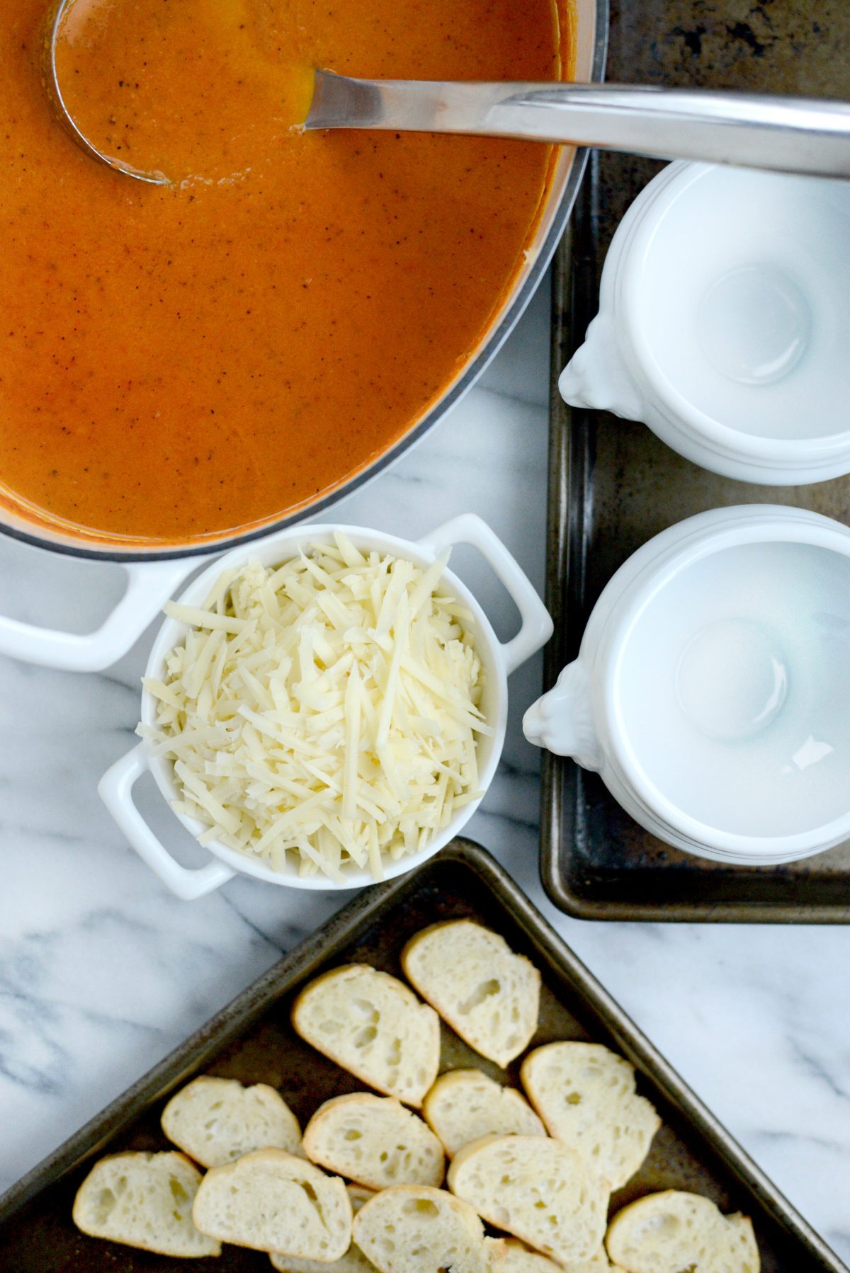 soup, cheese and toasted bread slices.