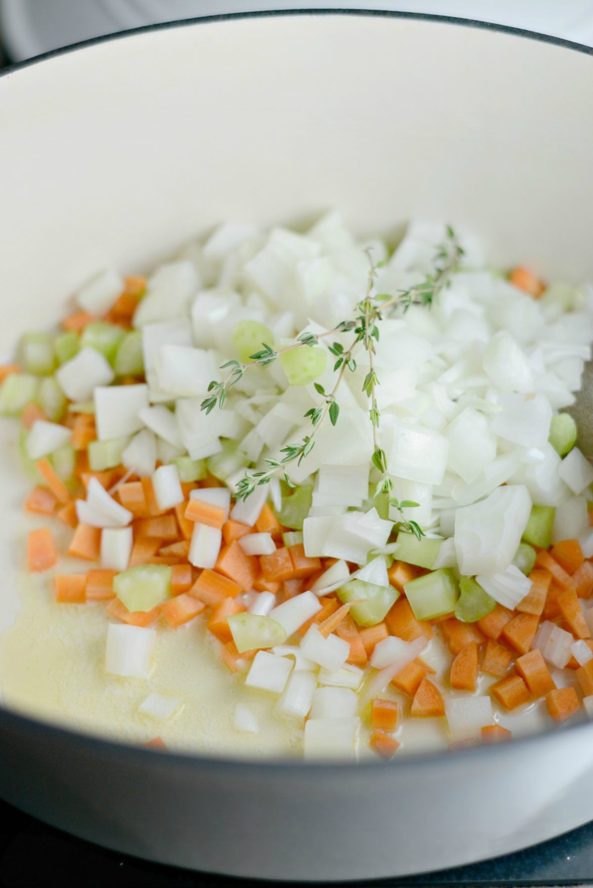 Add butter, carrots, celery, onion and thyme in dutch oven.