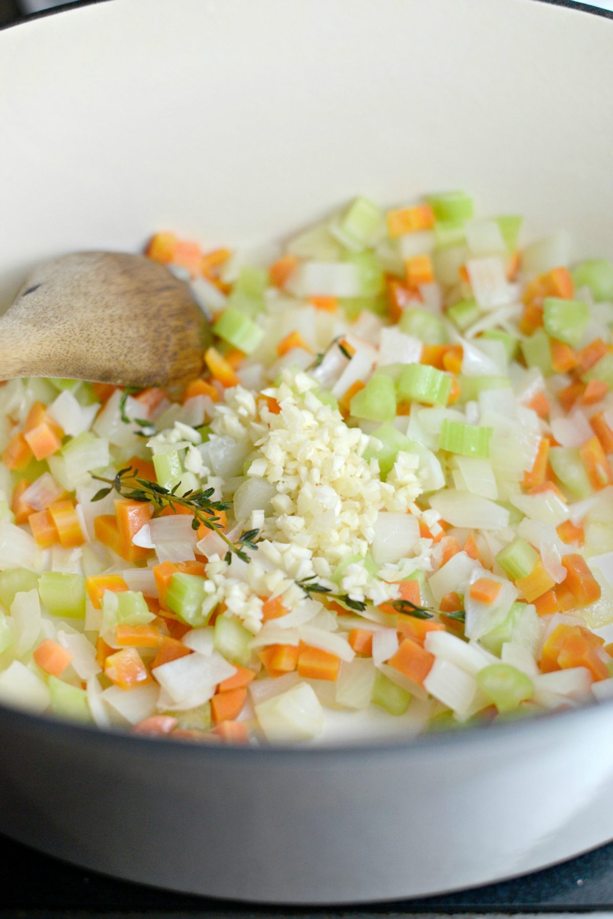 Add minced garlic to sautéed veggies