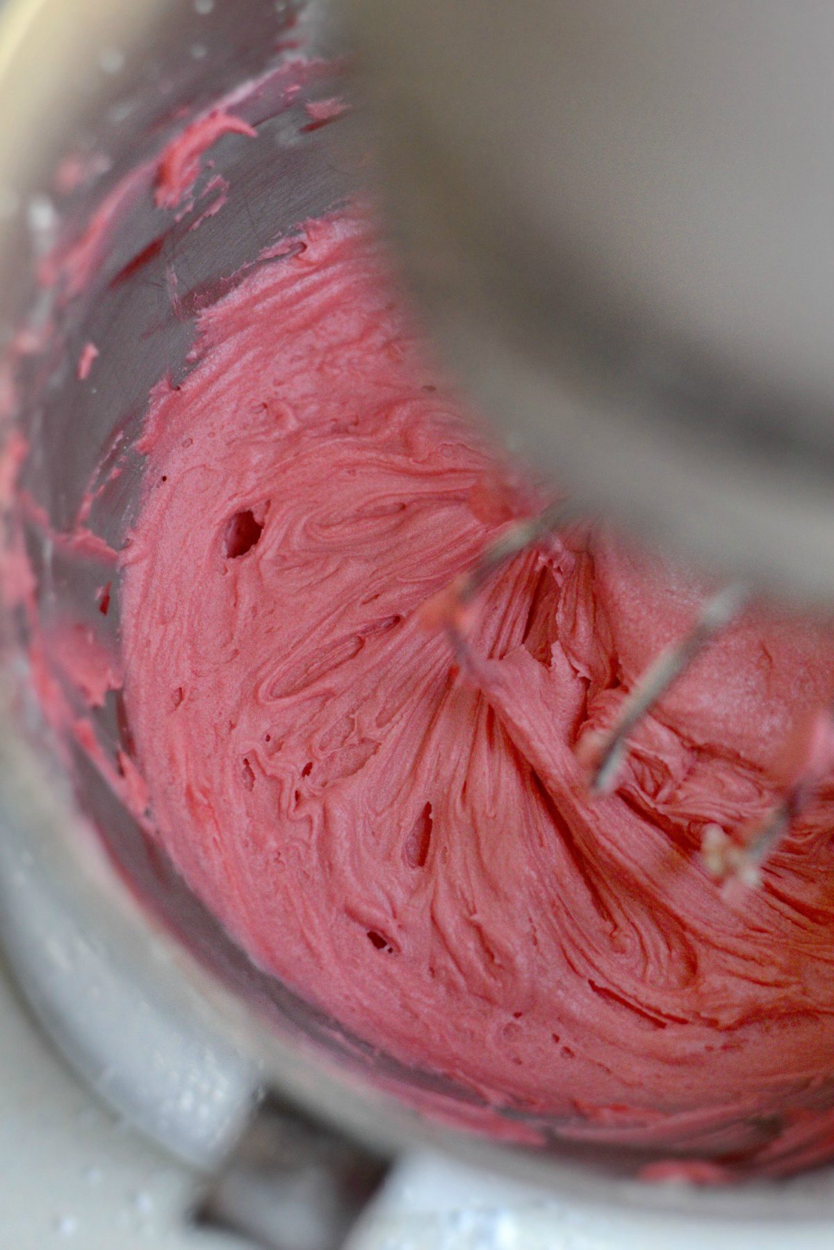 pink frosting in mixing bowl.