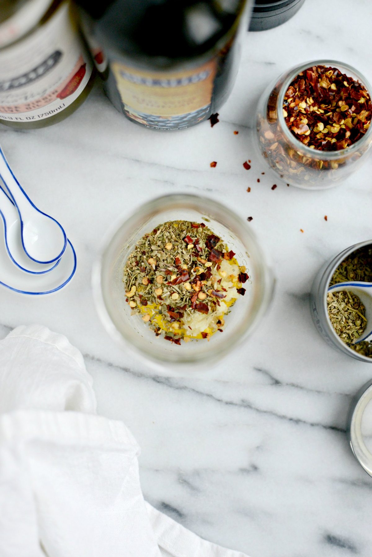 Add garlic, chili flakes and seasoning to a jar