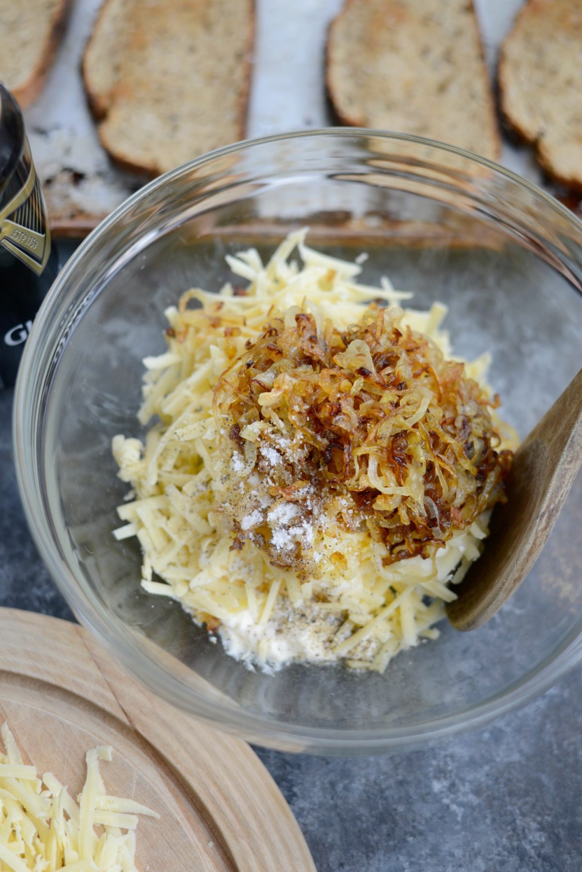 Cream cheese, mayo, shredded dubliner cheese, onions, salt and pepper in bowl.