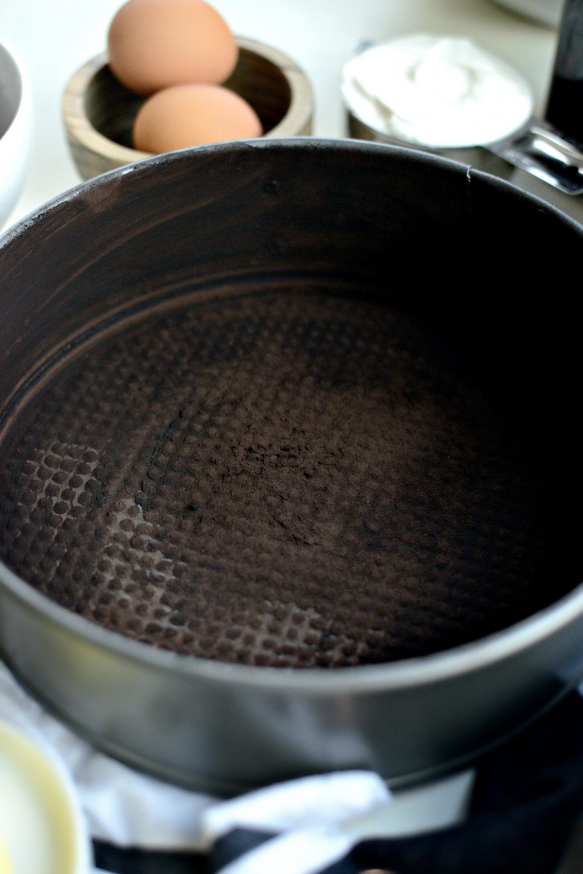 grease and dust spring form pan with cocoa
