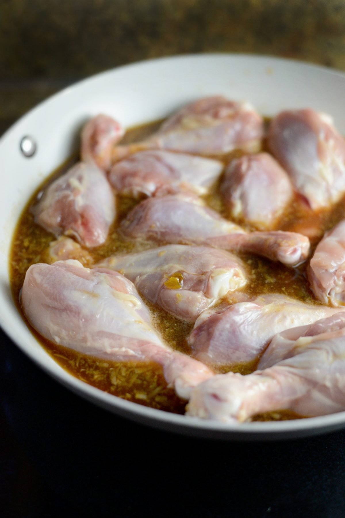 add glaze and chicken drumsticks to a wide sauce pan