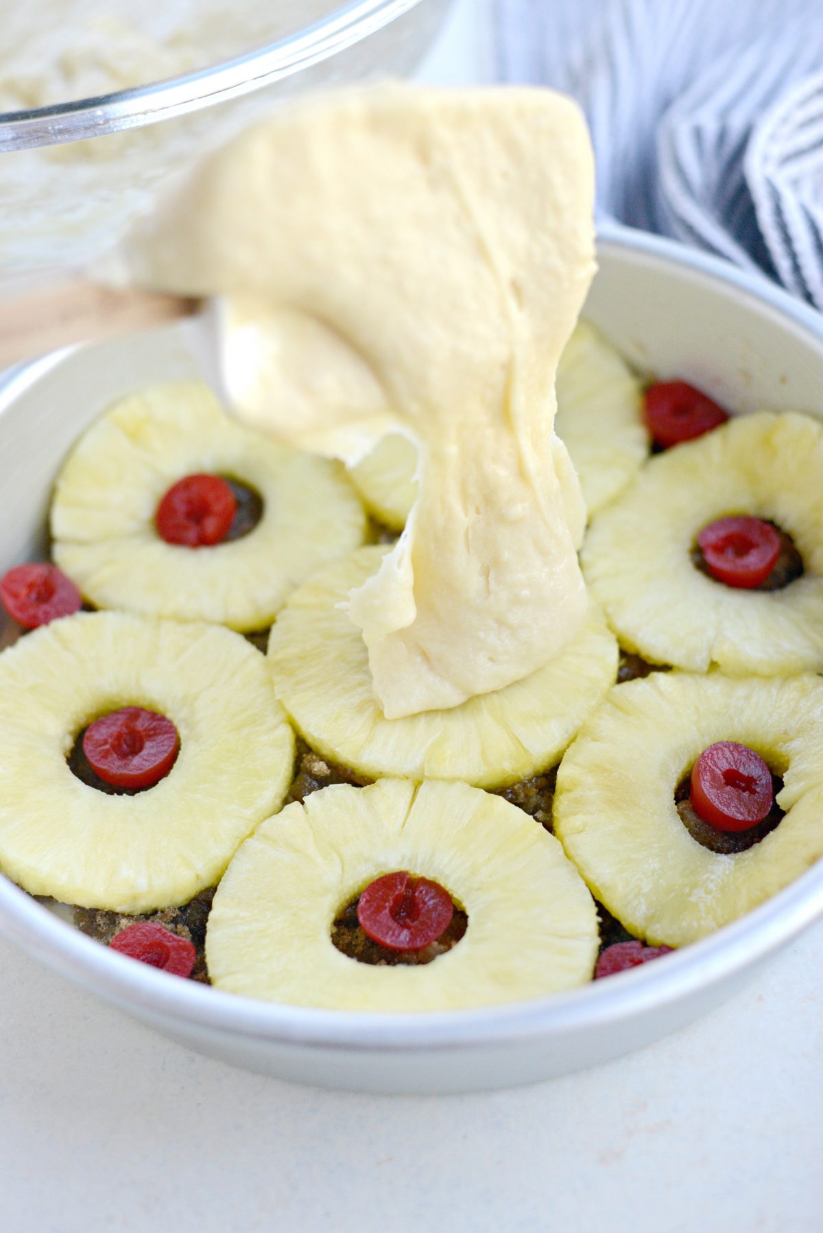 spoon over pineapples and cherries