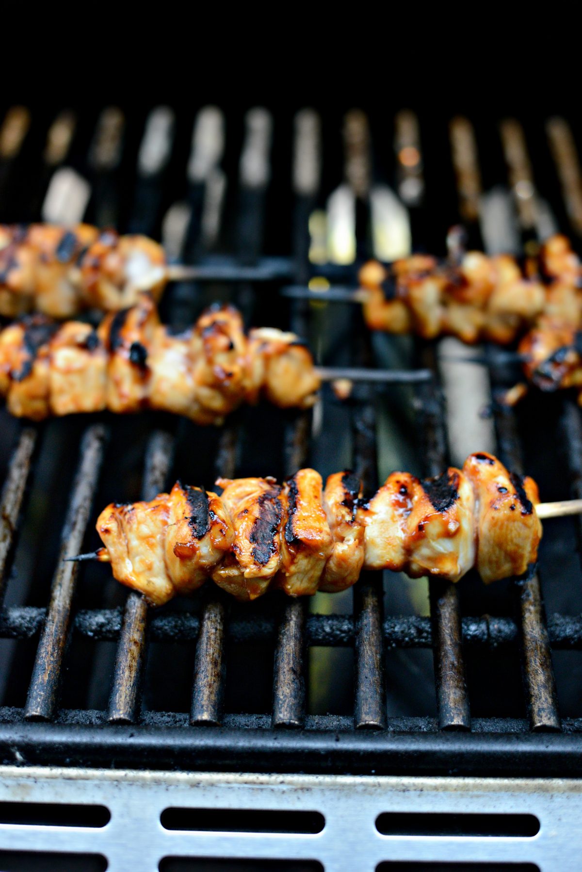 grilled chicken skewers on grill.