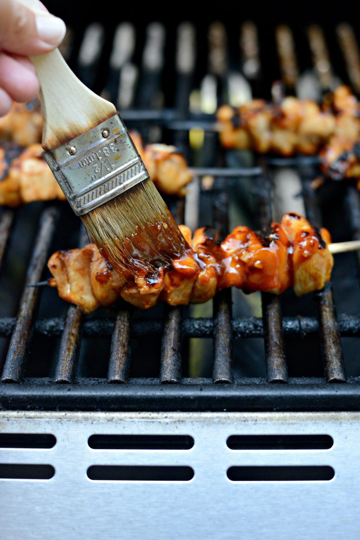 brush grilled chicken skewers with reserved sauce.