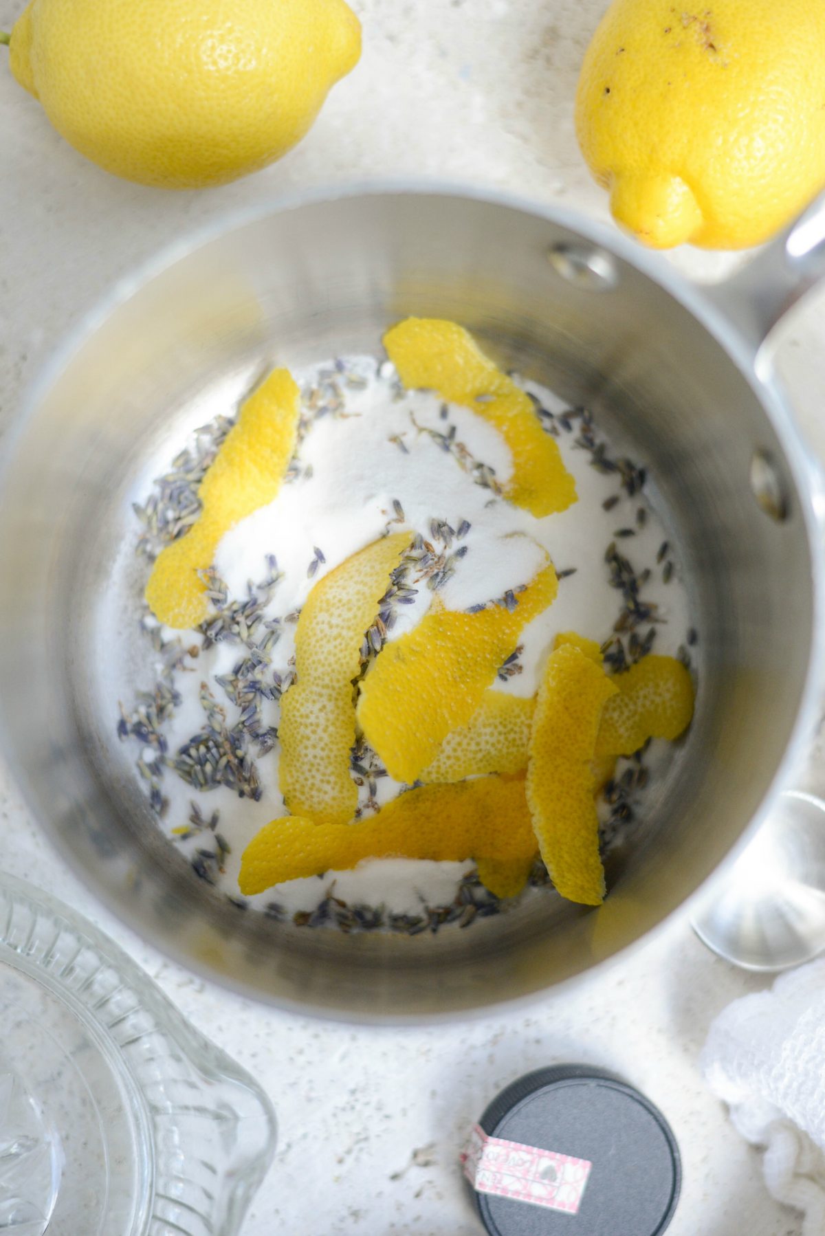 Add sugar, lemon rind and lavender to a saucepan.