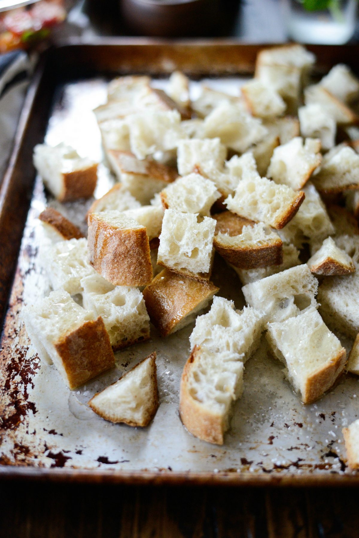 cubed bread on rimmed baking sheet