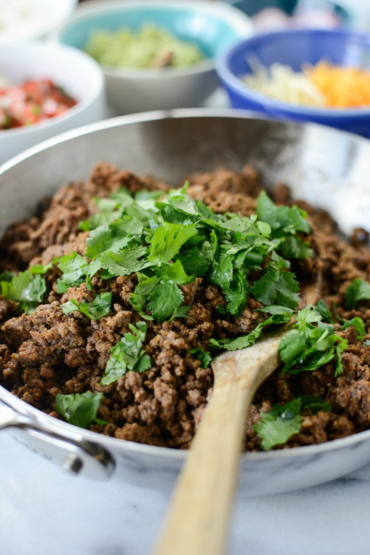 Add cilantro to cooked ground beef.