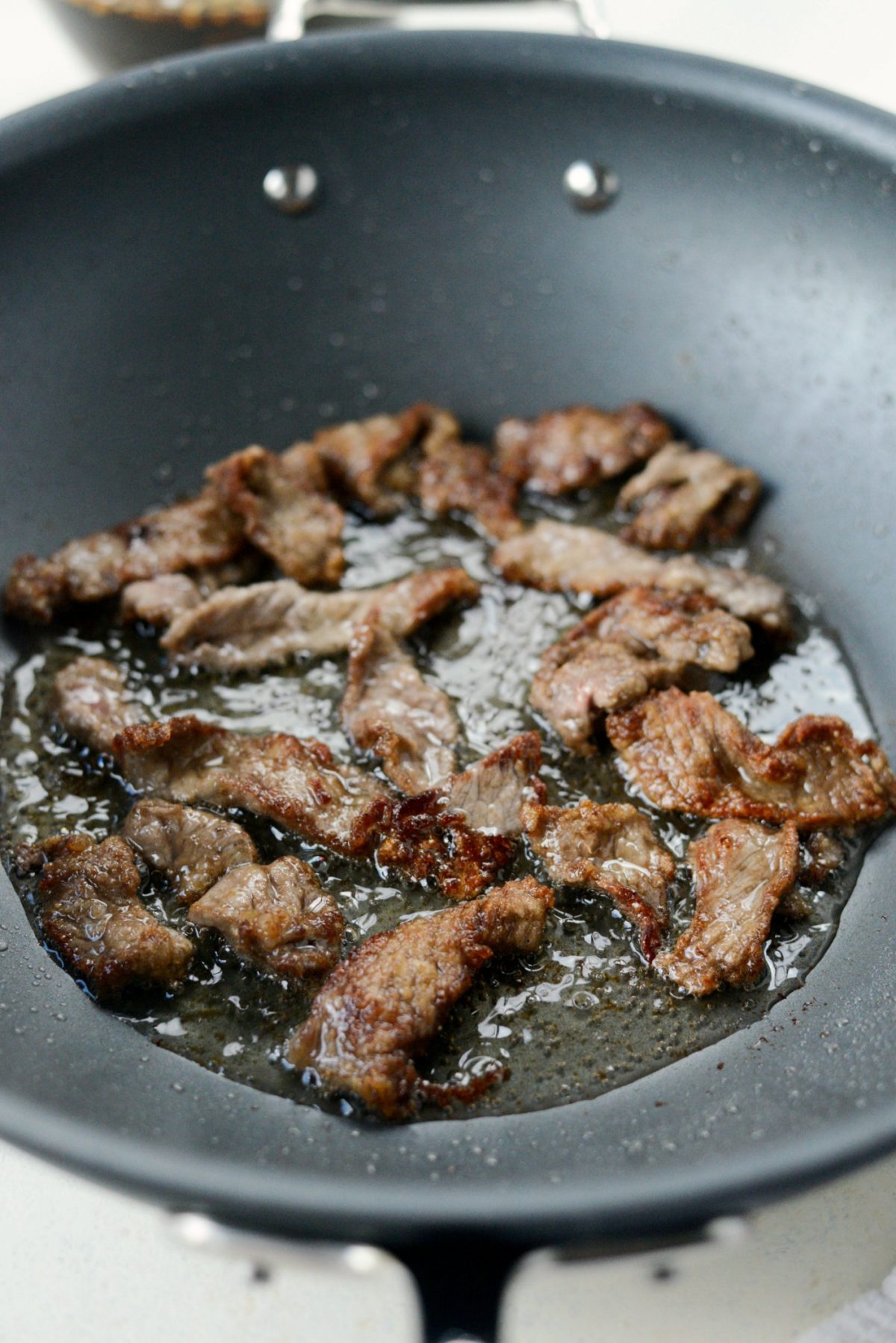 Crispy browned beef in pan.