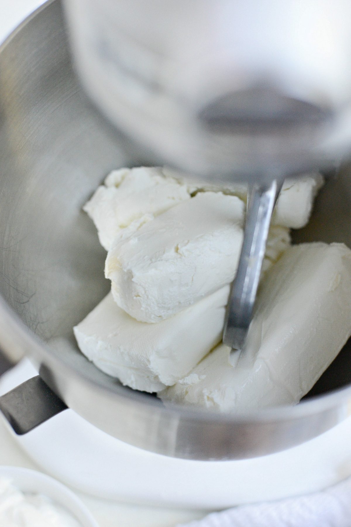 Add cream cheese and goat cheese to bowl of stand mixer