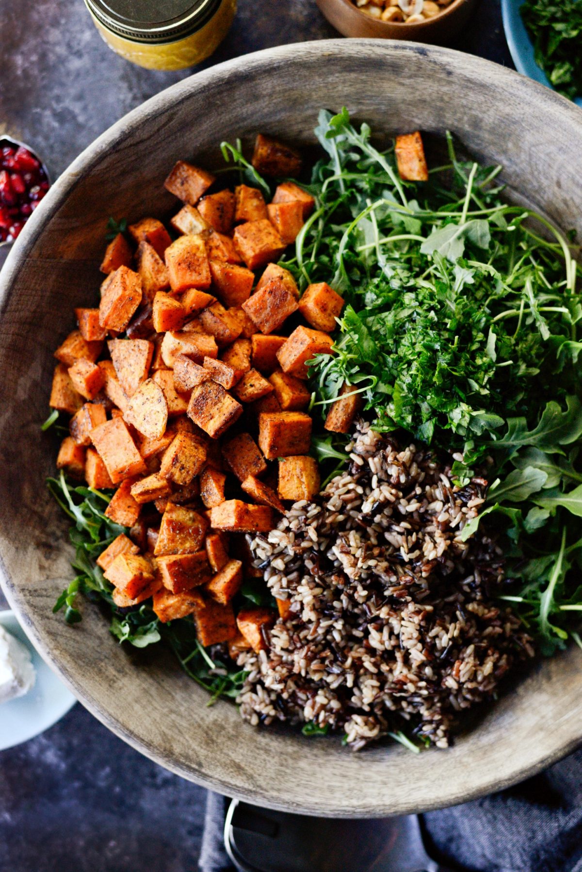 add roasted sweet potato, cooked rice, arugula and herbs