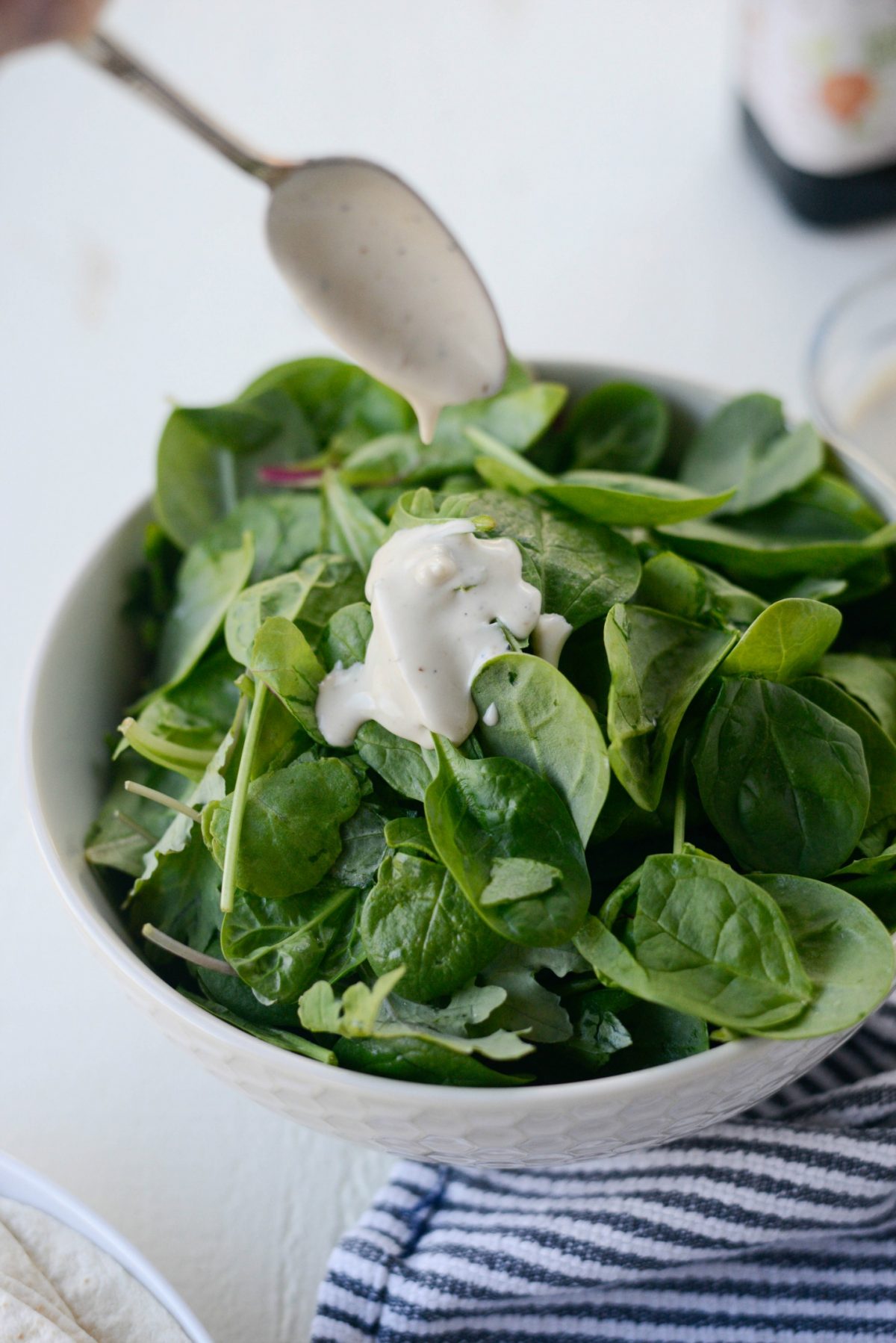 dress leaving spinach mixture with dressing.