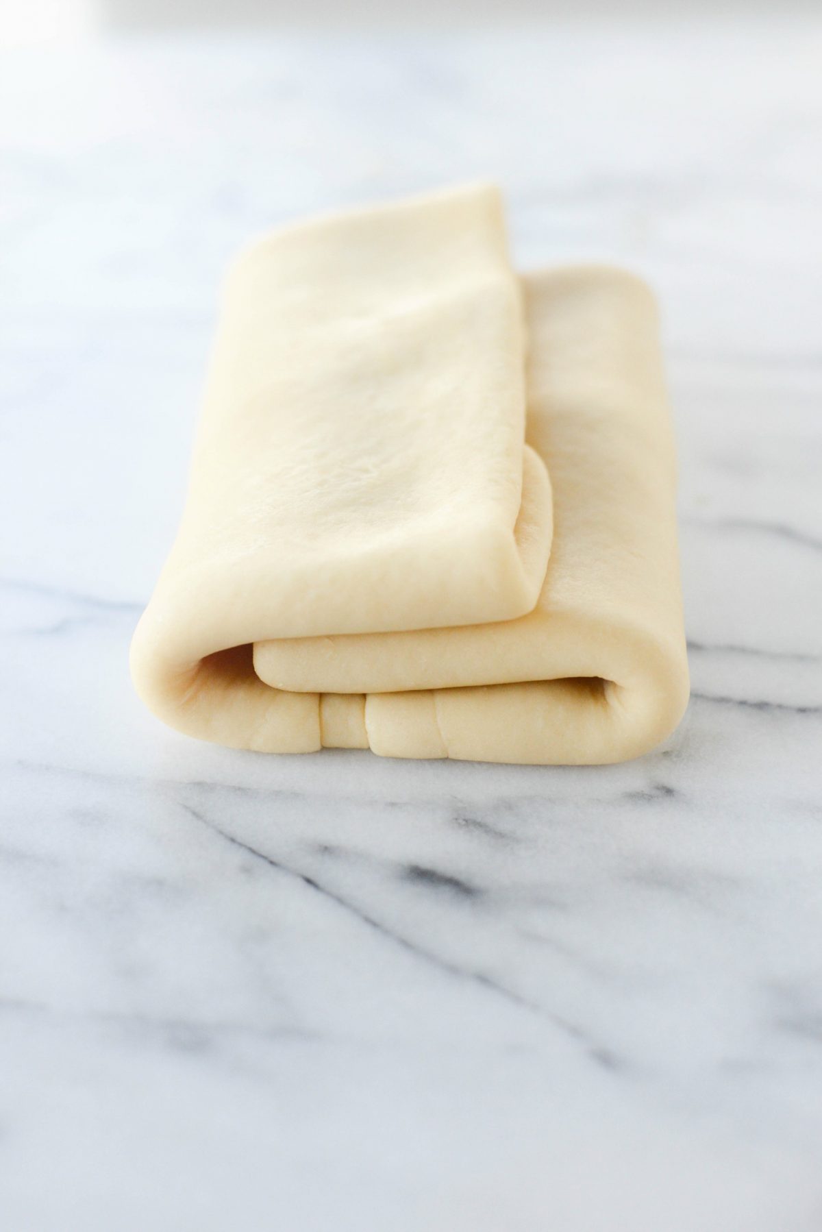 Once you've rolled and folded the dough, wrap it tightly in plastic wrap and refrigerate for 4 hours or overnight