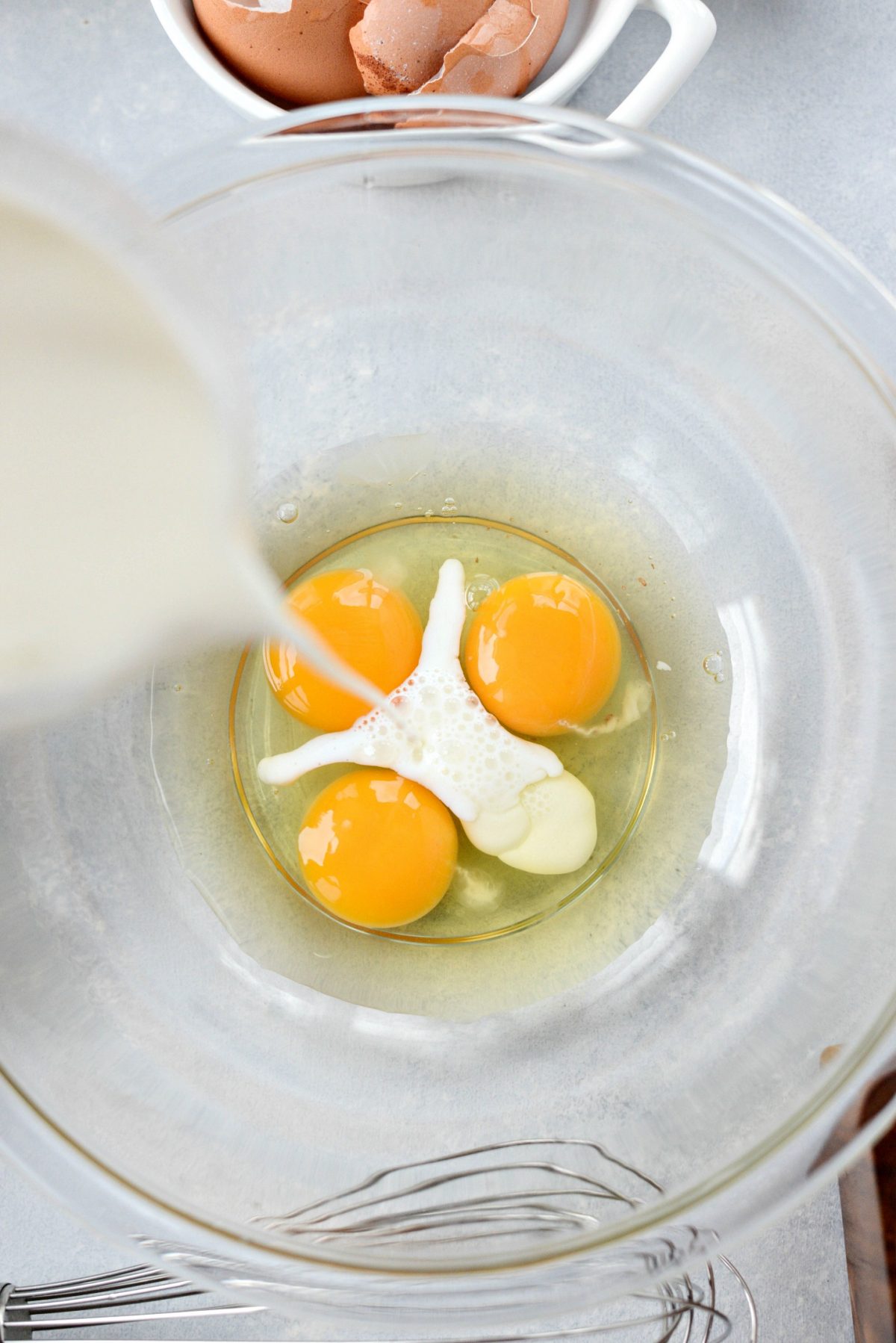 Eggs and milk in mixing bowl.