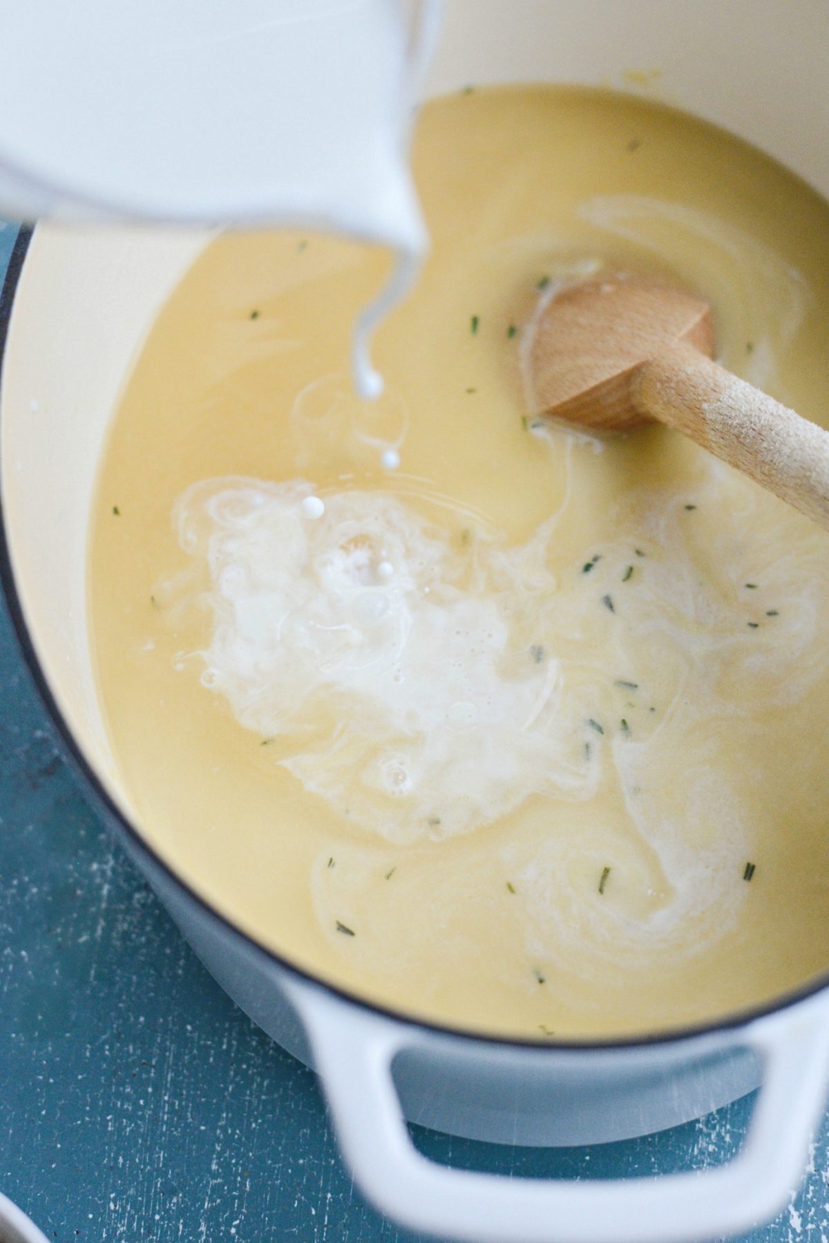 pouring half and half with turkey stock into the pot.