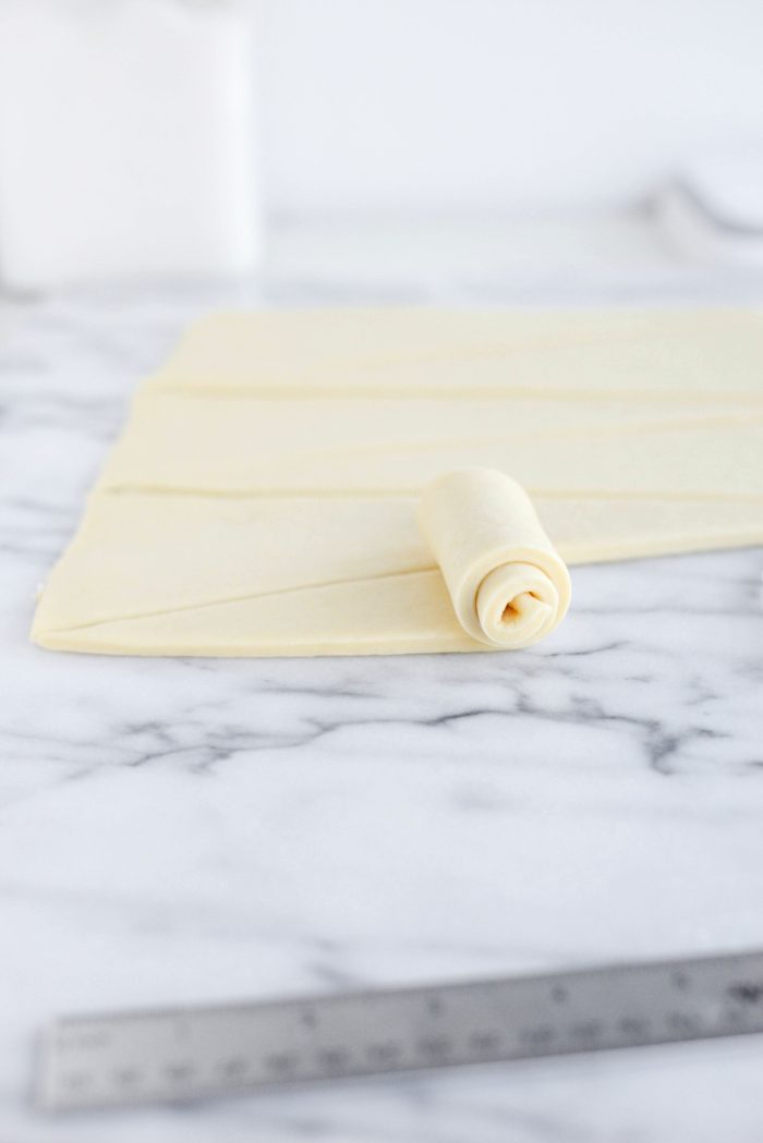 starting at the wide end, roll towards the pointed end