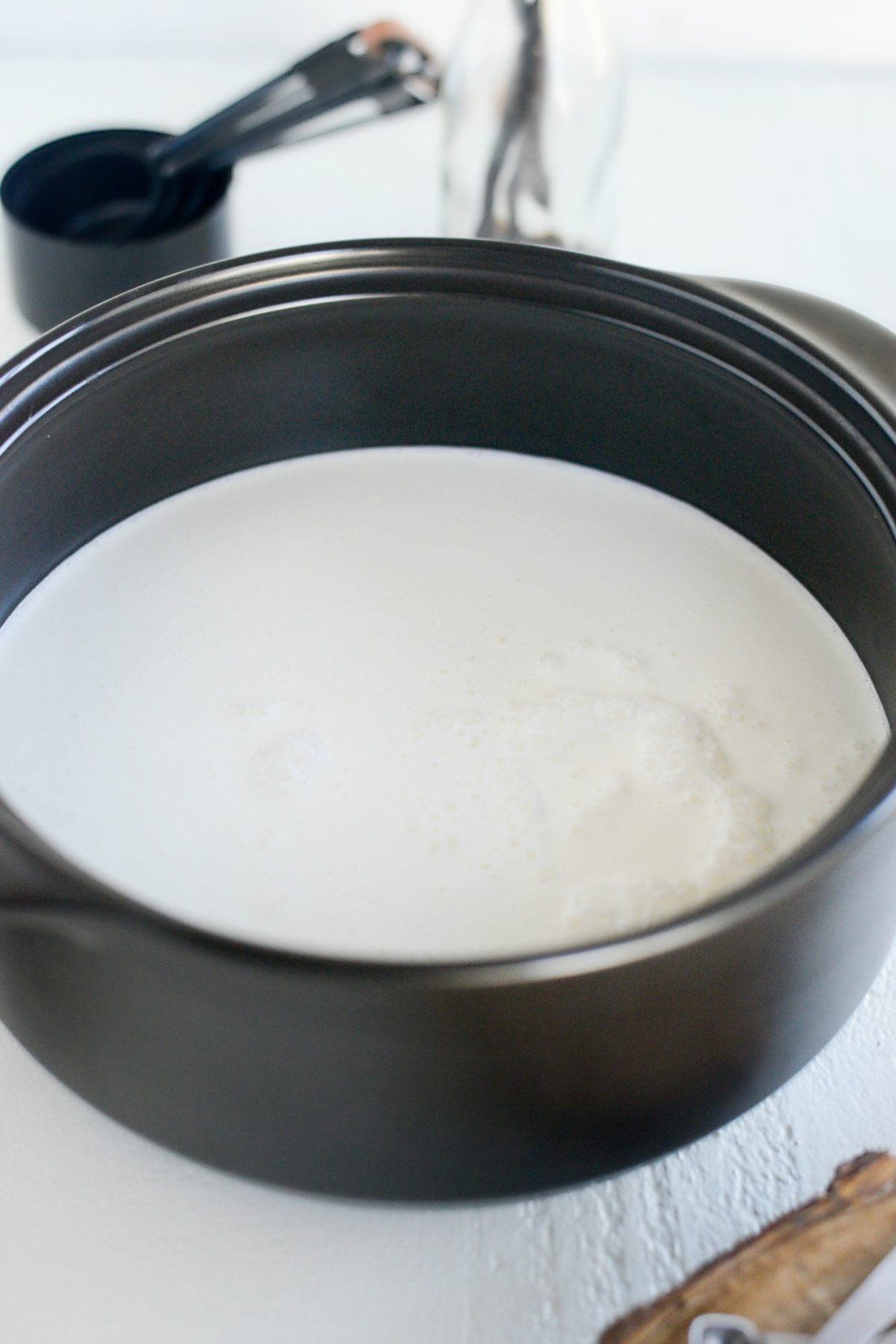 add milk and cream to pot