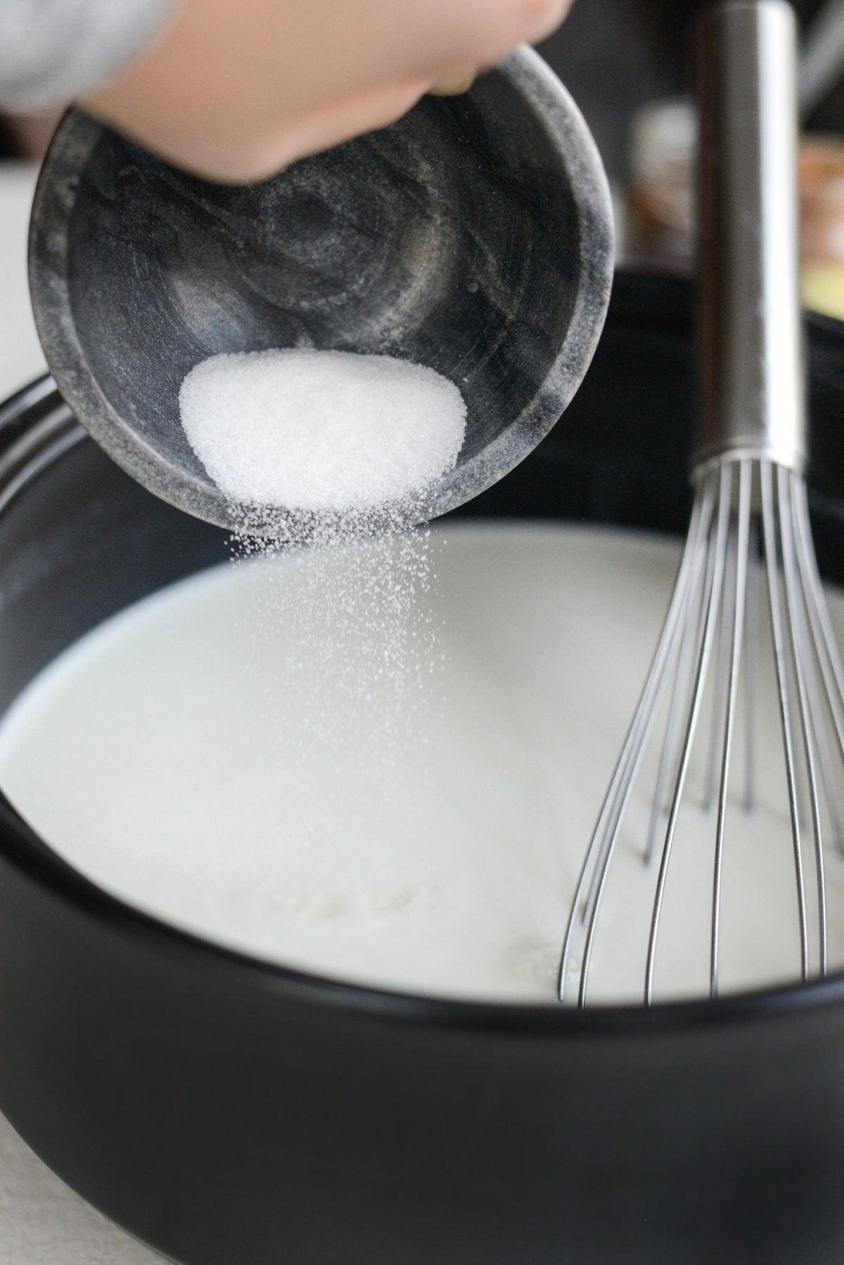 whisk in sugar to hot milk and cream.
