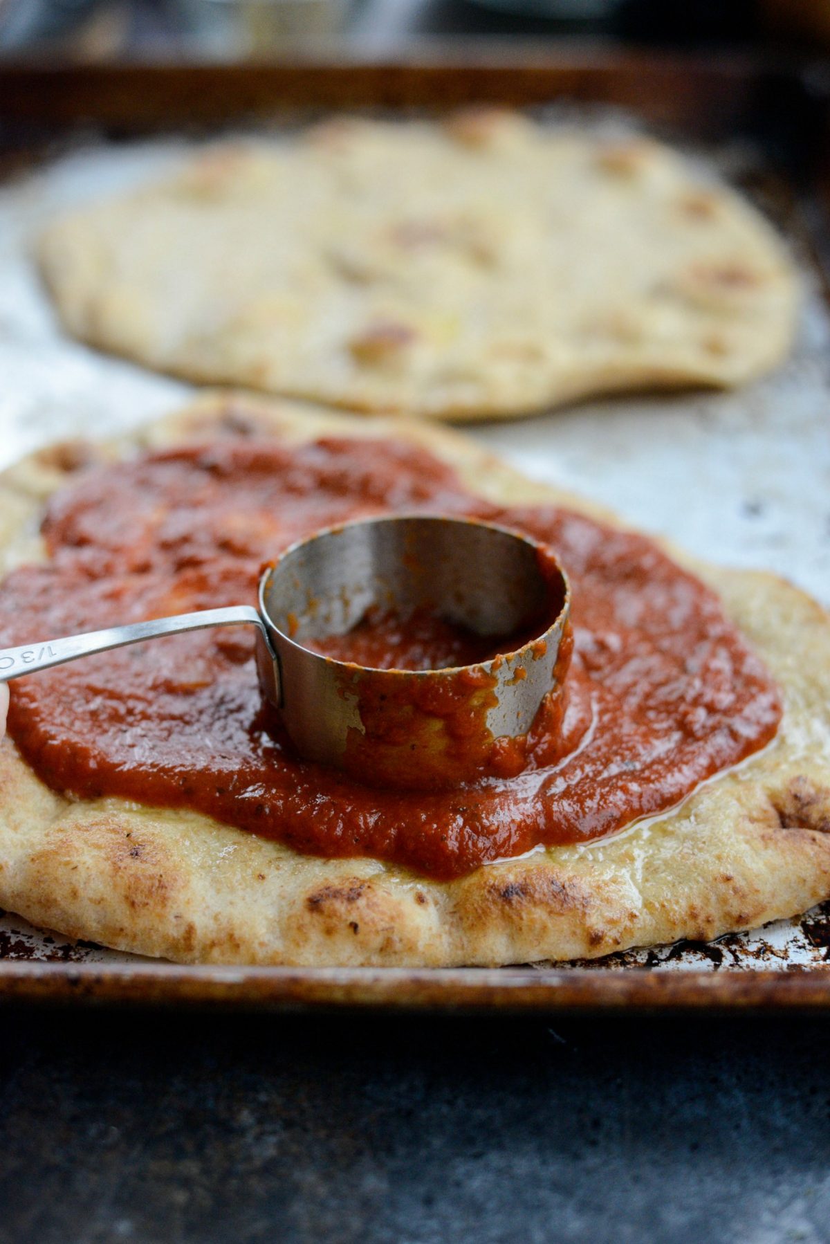 Spread the marinara evenly on the naan