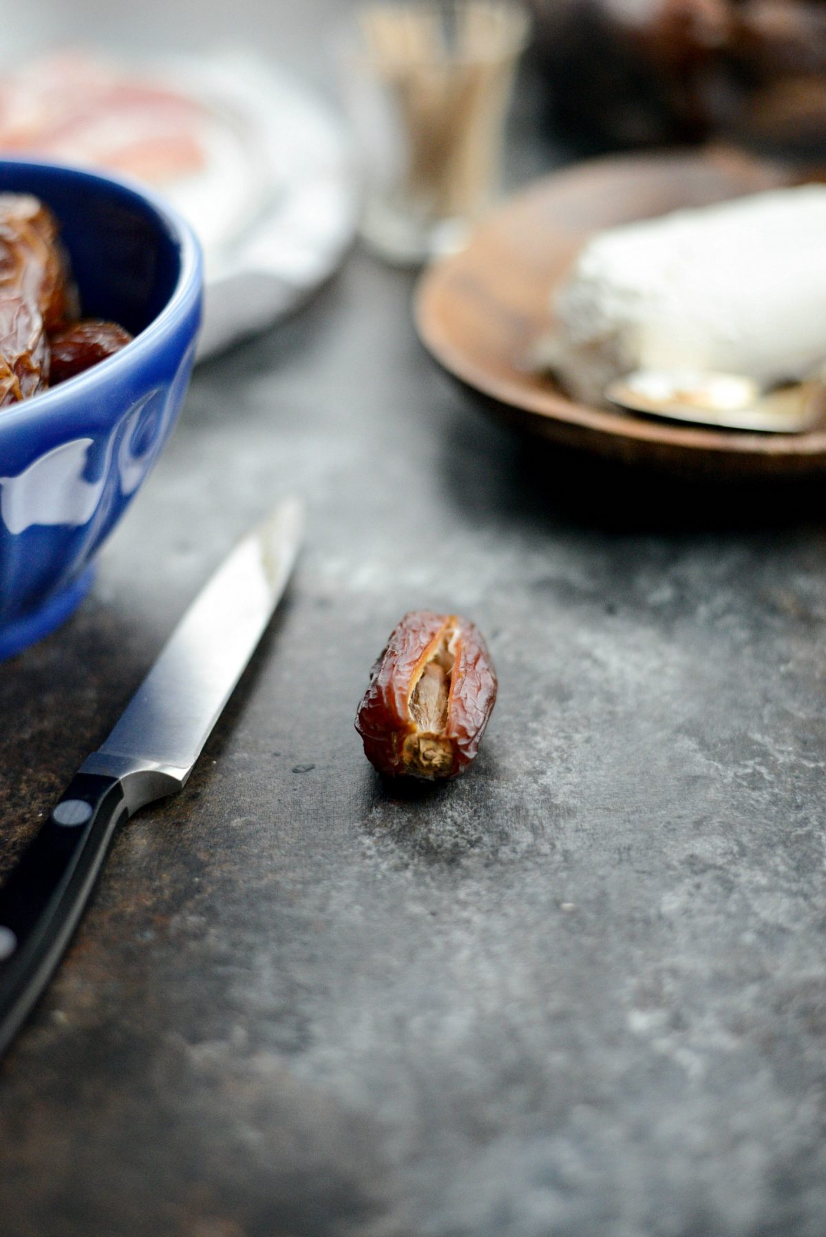 Prep dates by slicing and removing pit.