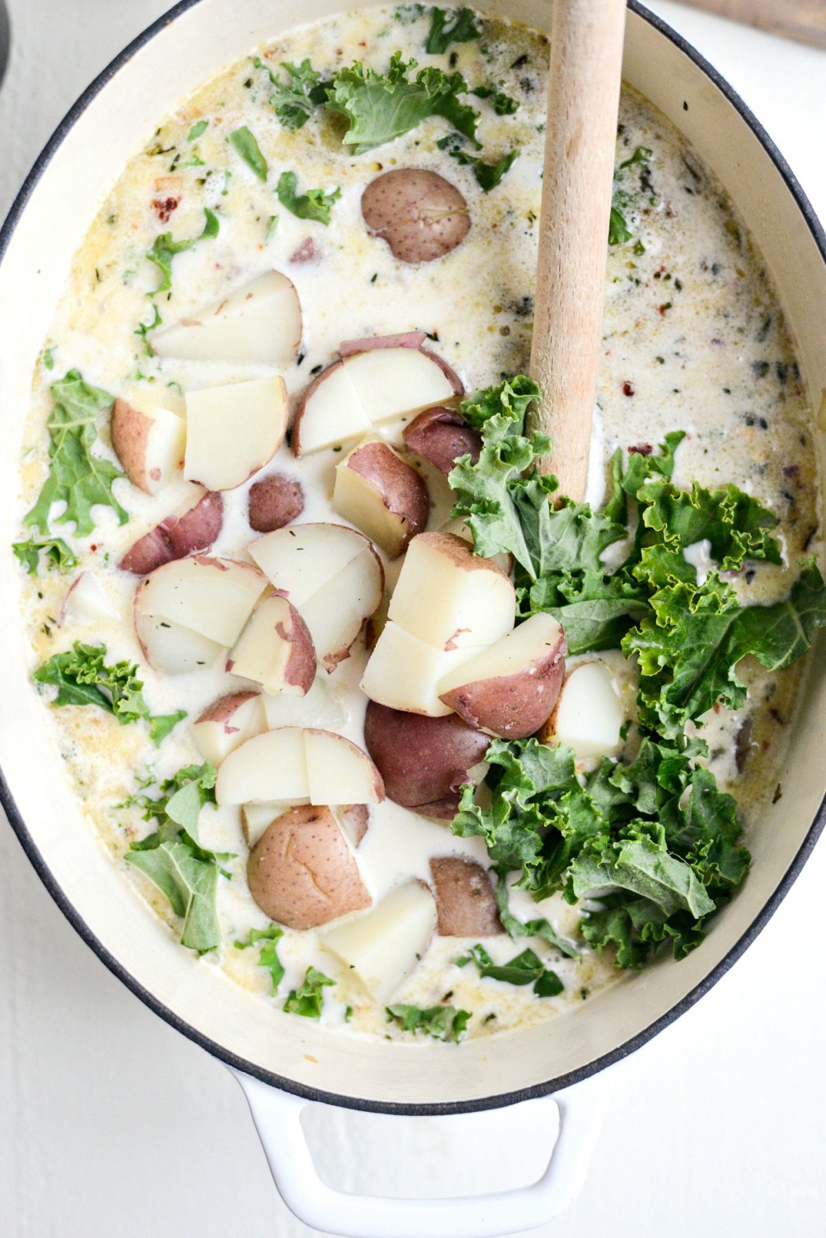 Add in diced potatoes and kale. Heat the potatoes through and wilt the kale.