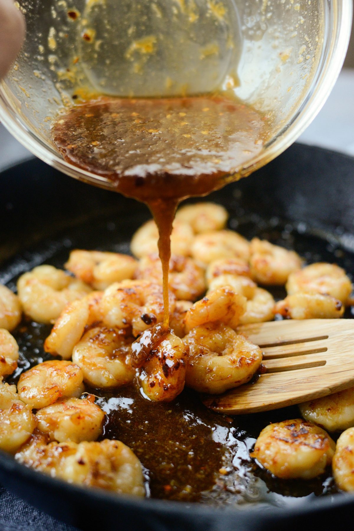 pour in half of the remaining sauce over cooked shrimp