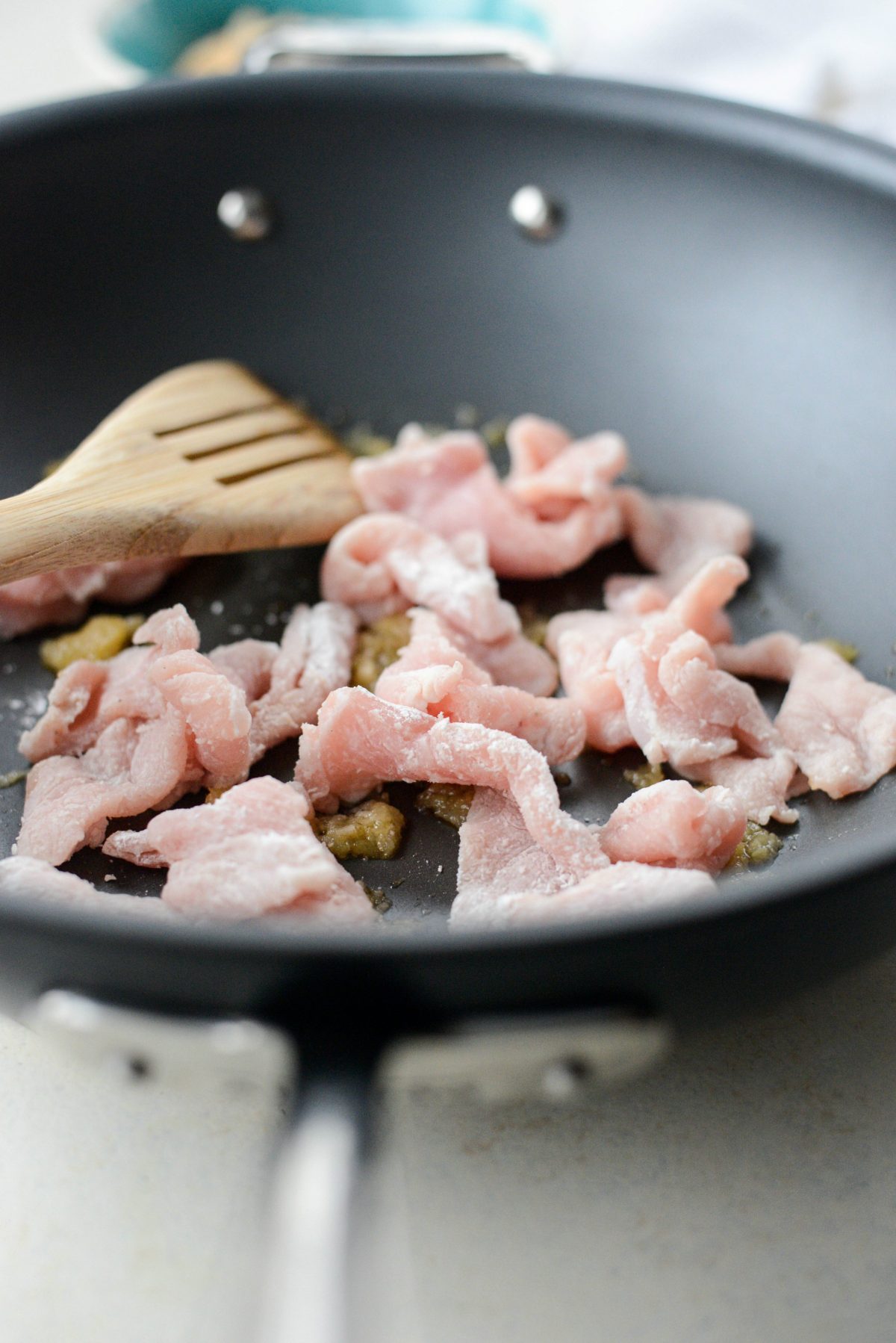 Then working in batches stir-fry the pork in batches, adding more coconut oil as needed until the pork in cooked through and crispy.