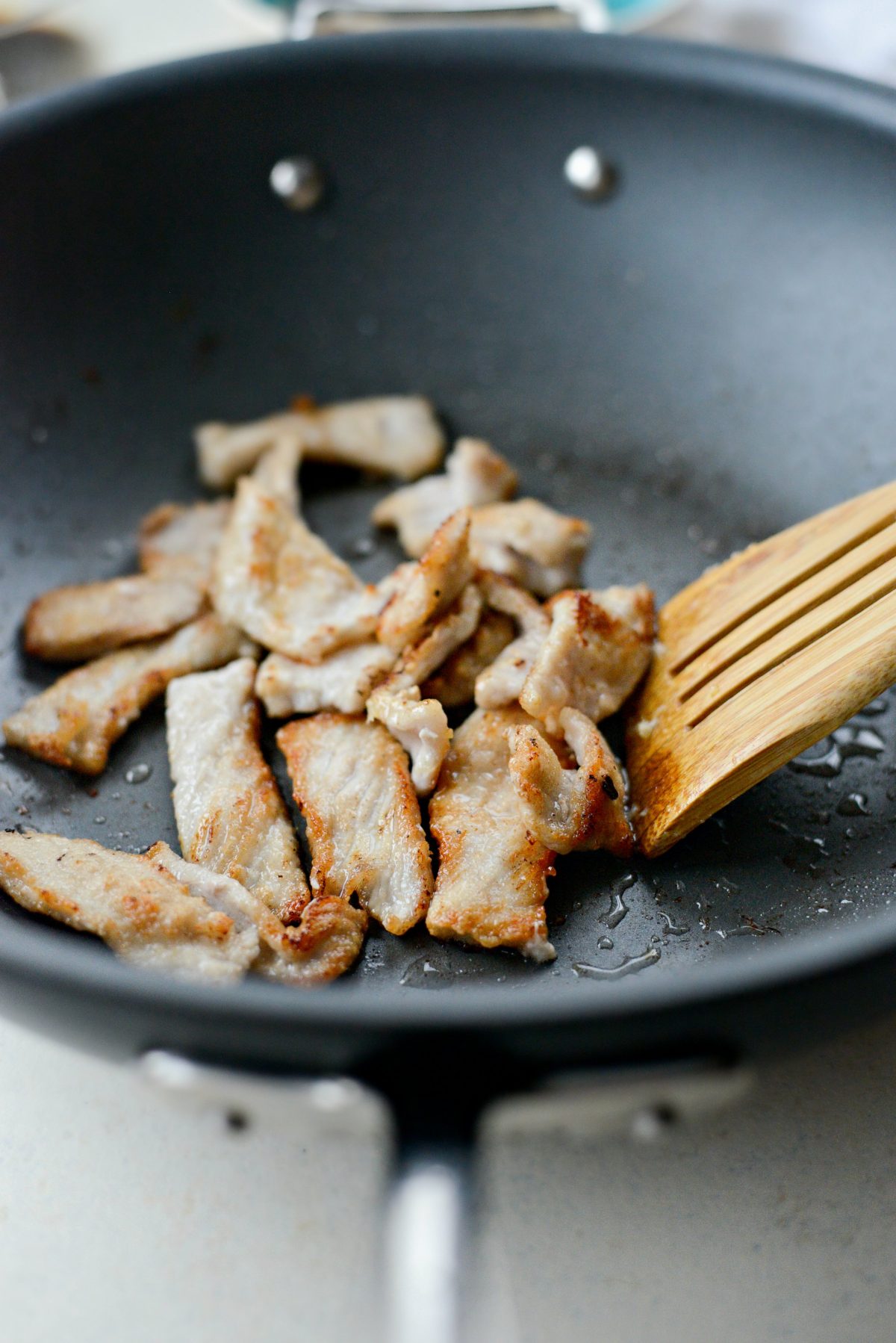 crispy pork pieces in wok.