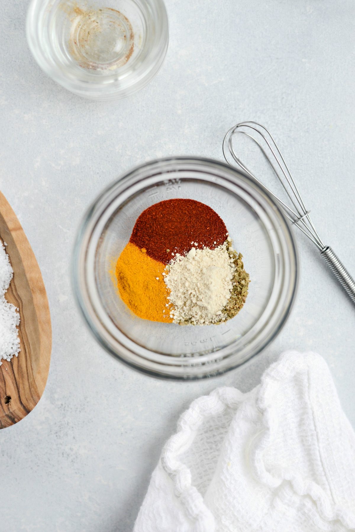 measure and add spices to a bowl or jar