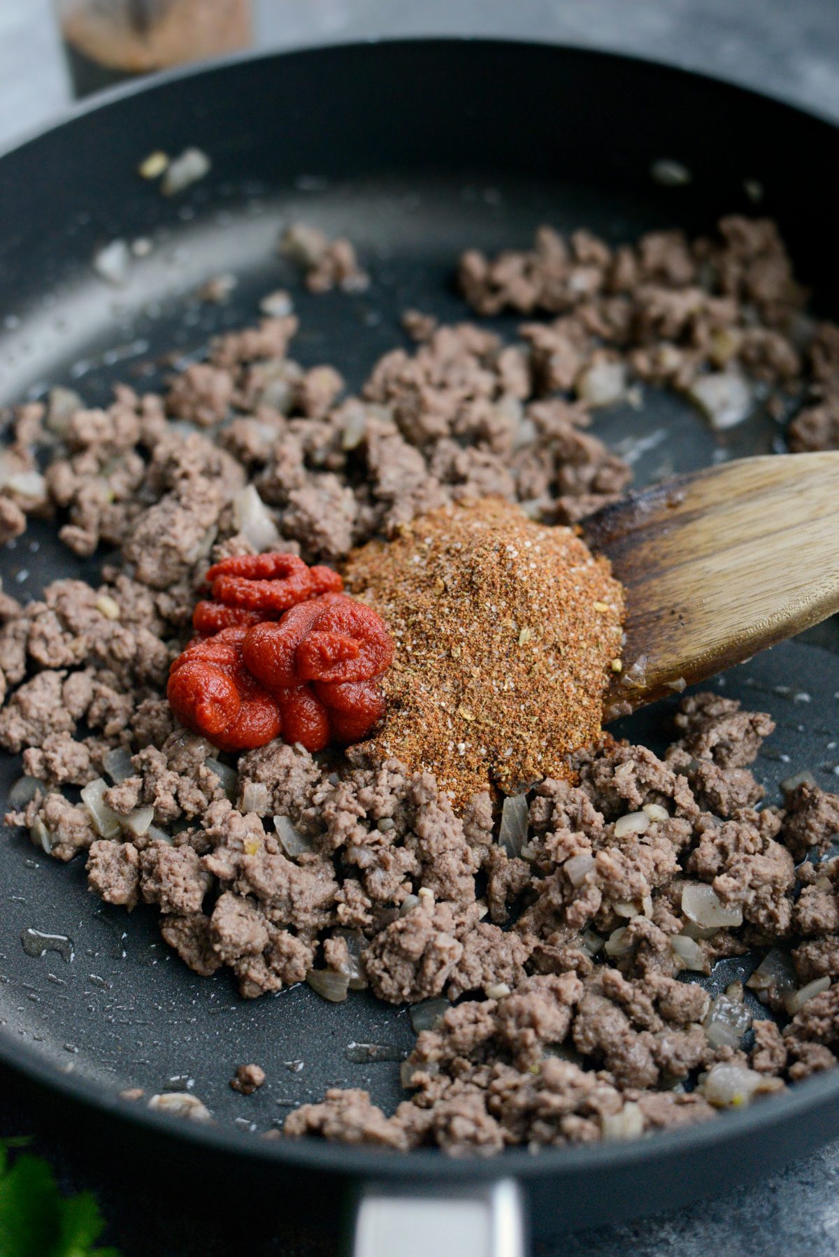 add tomato paste and taco seasoning to beef mixture.