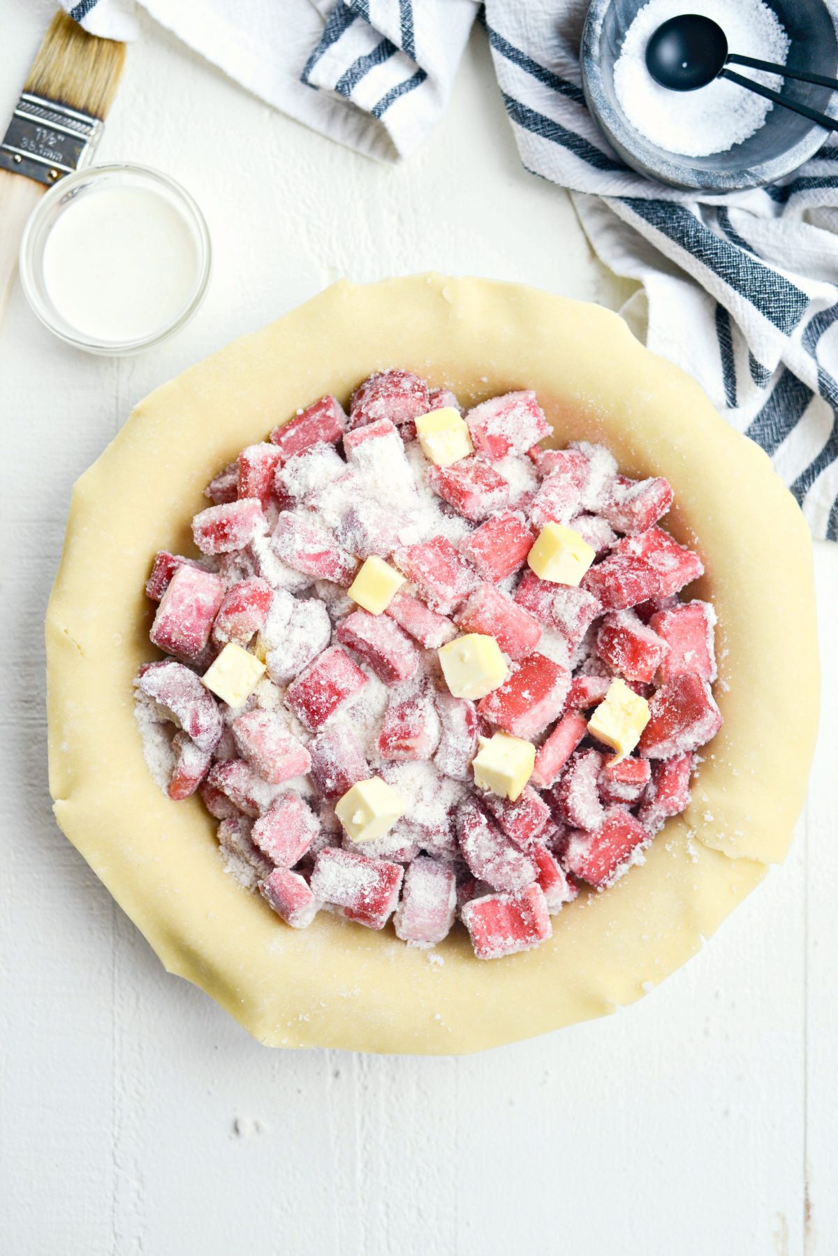 add rhubarb to prepared pie crust and dot with cubed butter