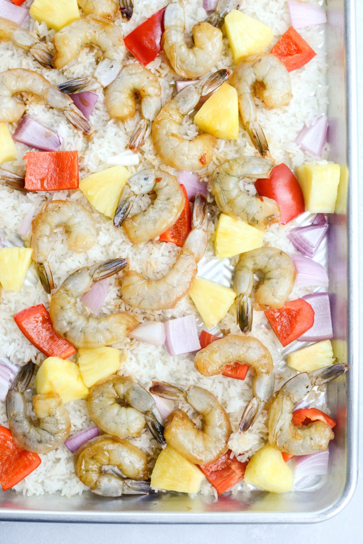 add shrimp to sheet pan with rice and veggies