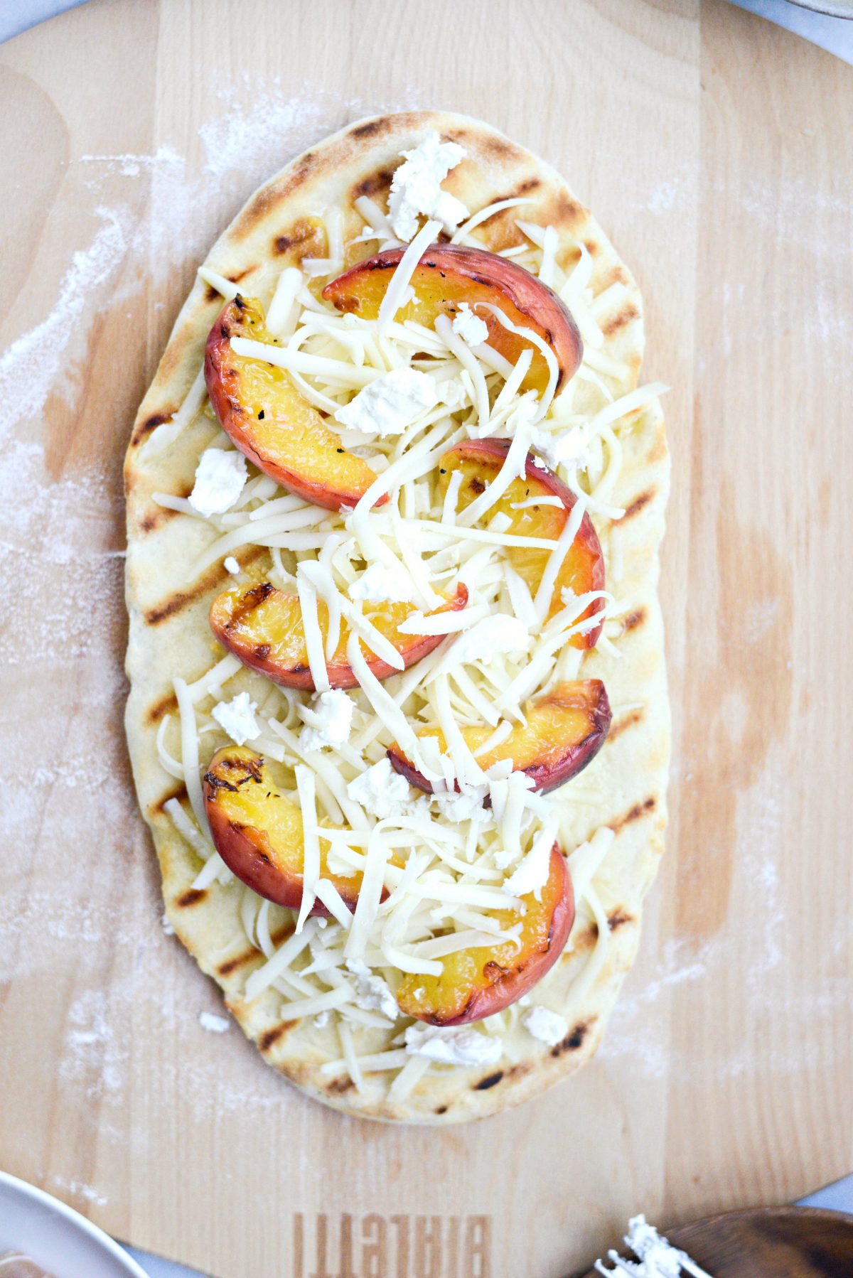 then topped with grilled peaches, goat cheese and more mozzarella.